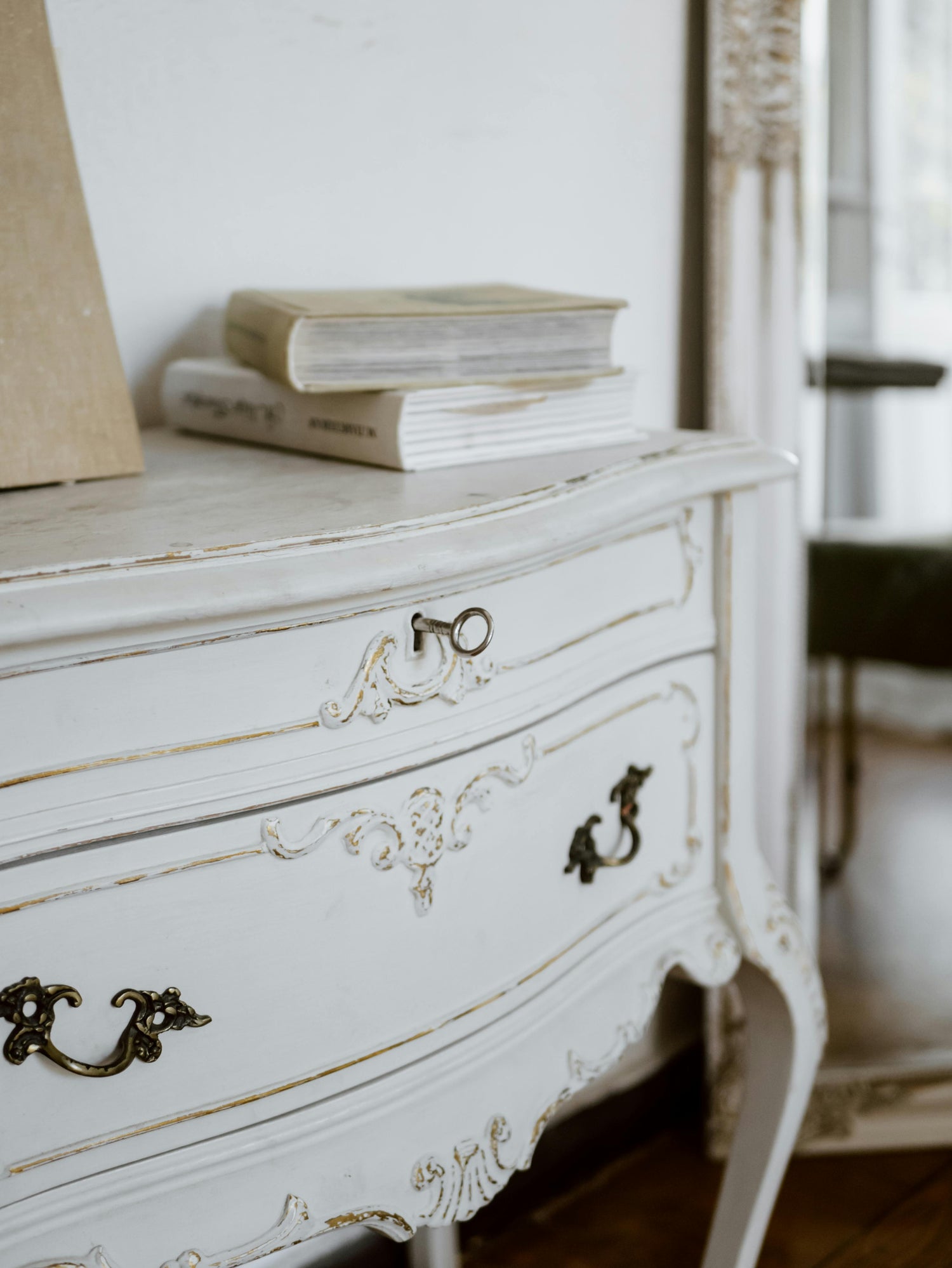 Vintage hardcover books on a white dresser 